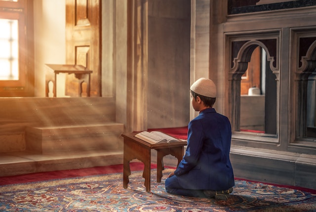 A kid reciting the Quran peacefully