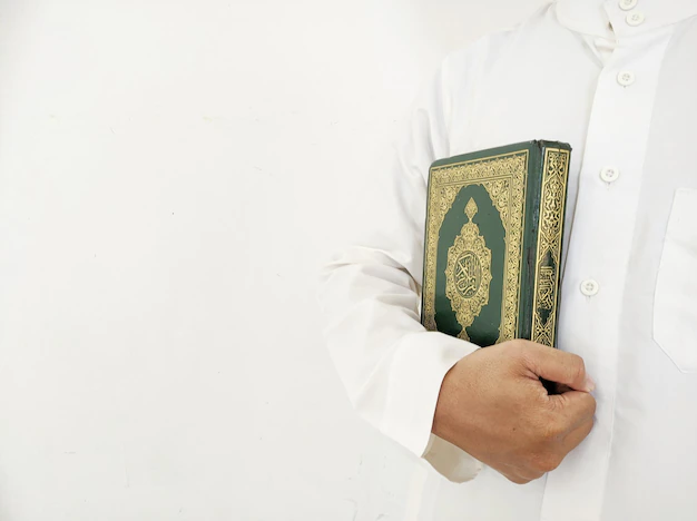 Muslim man holding the Holy Quran