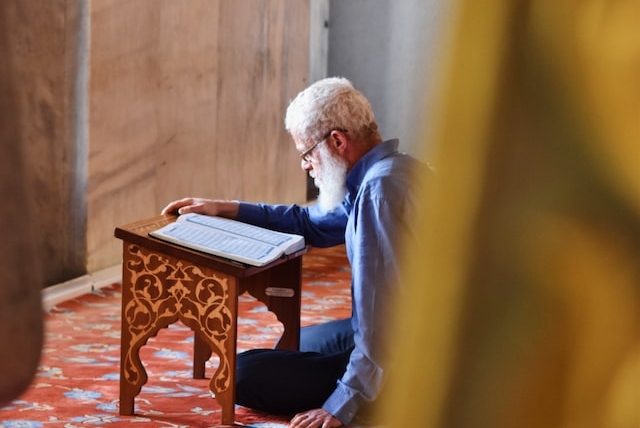 An old man reciting the Holy quran in the Mosque