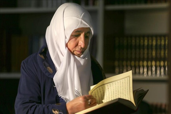 Muslim old woman reading quran