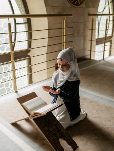 Little girl reading the Holy Quran